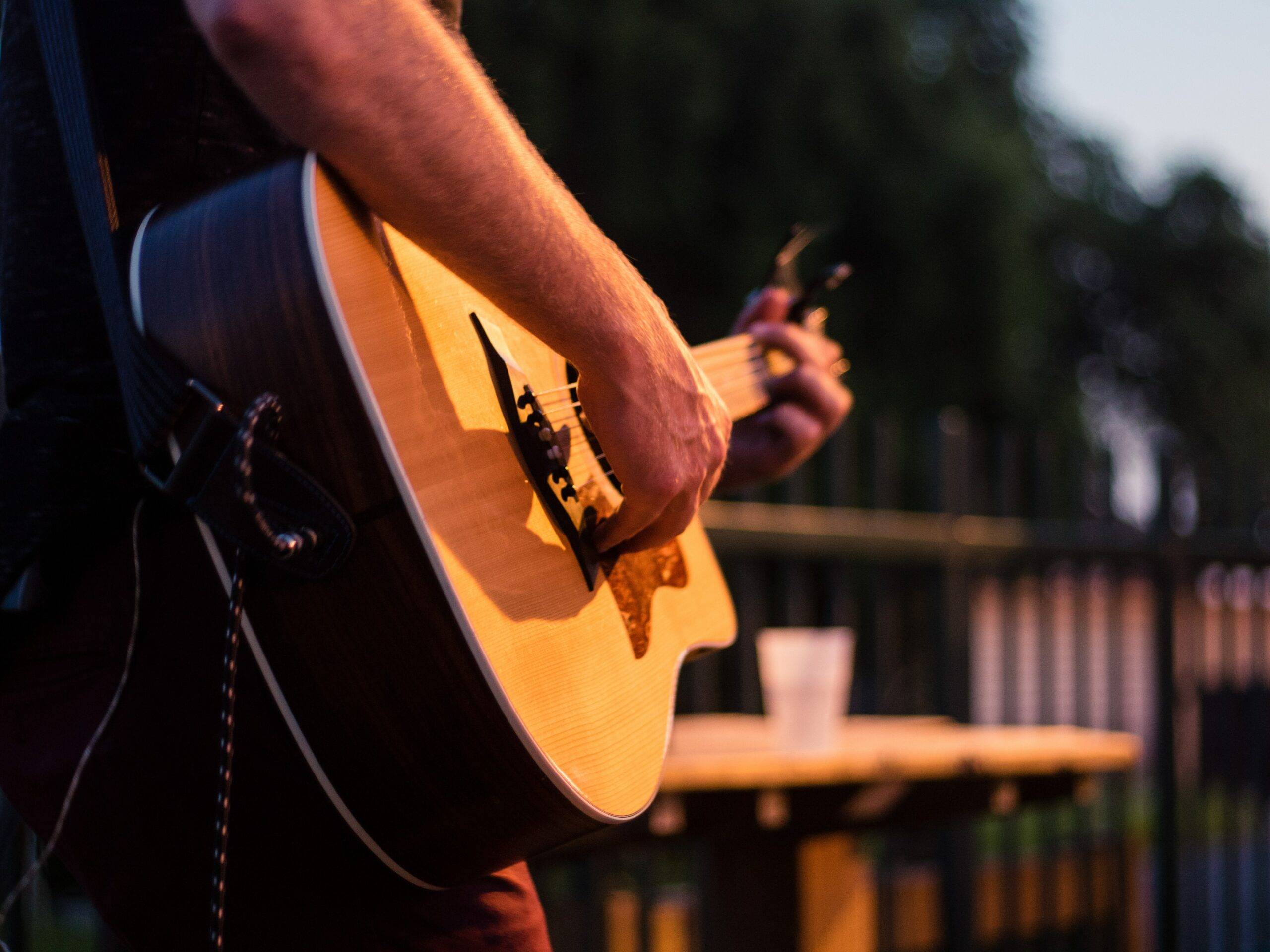 Image of a man playing guitar for an audience