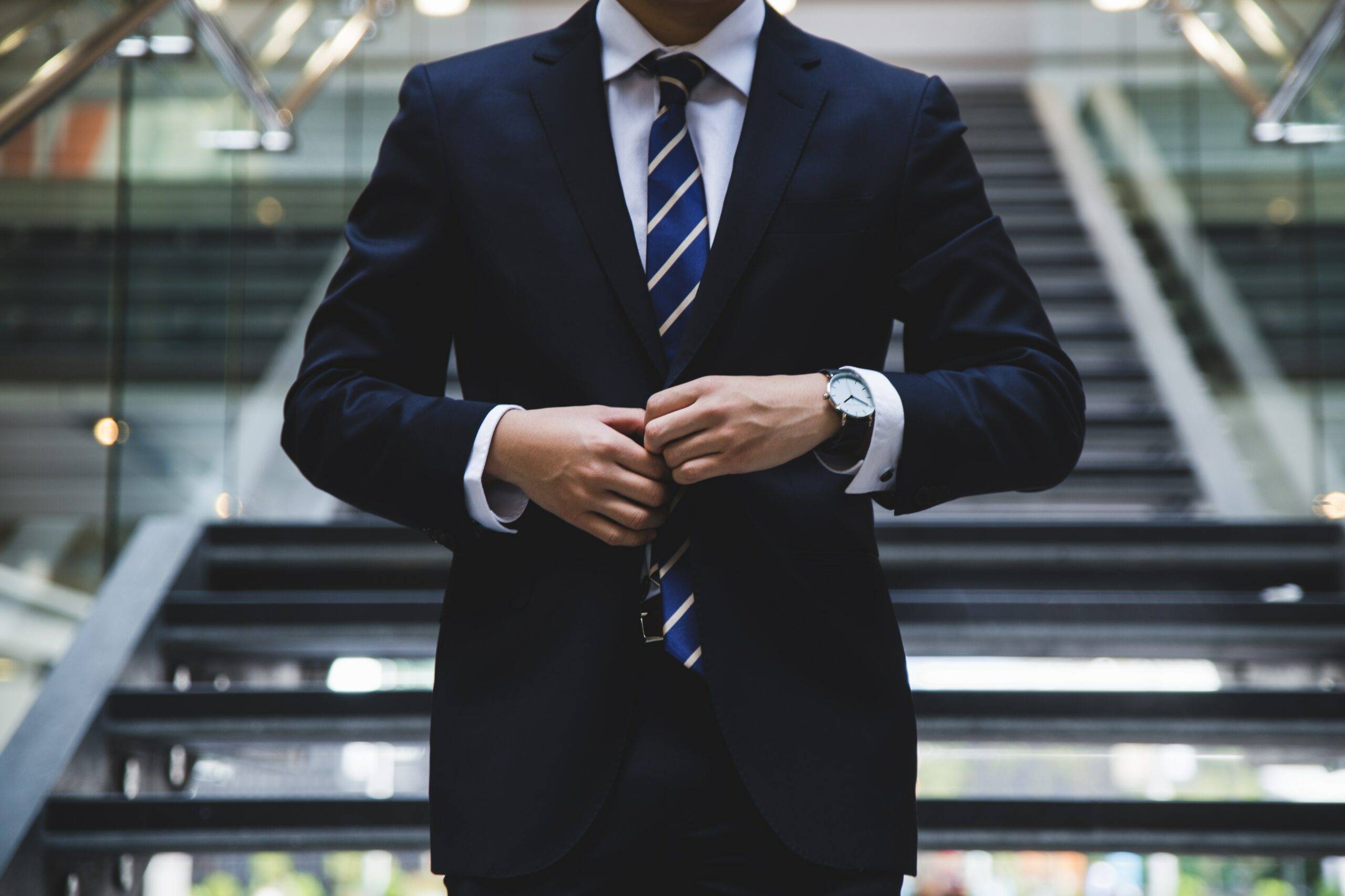 person standing near the stairs in a nice suit