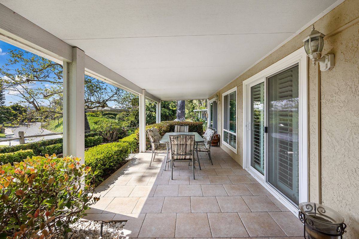 Outdoor living area covered patio with dining set to sell your Laguna Woods home