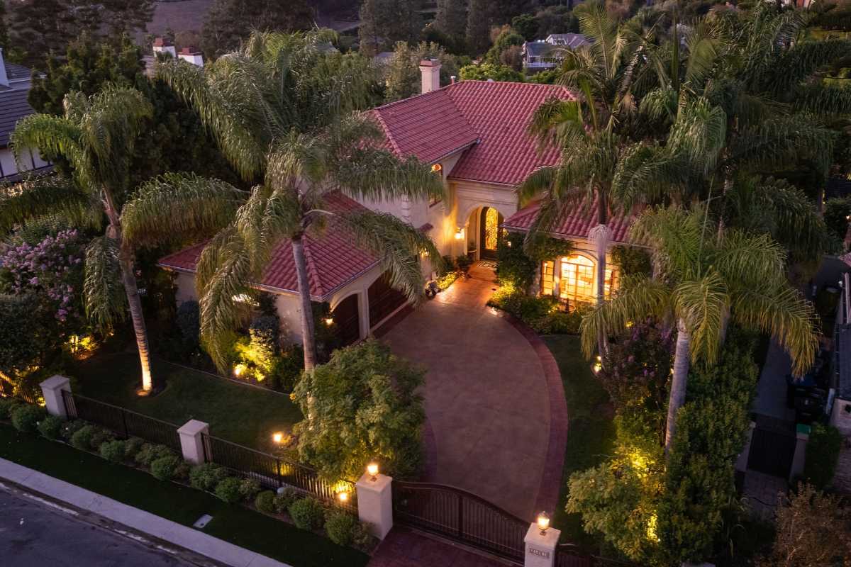 Aerial view of the Laguna Hills home for sale with a tile roof and gated driveway, representing polished presentation and smart marketing strategy for home sellers