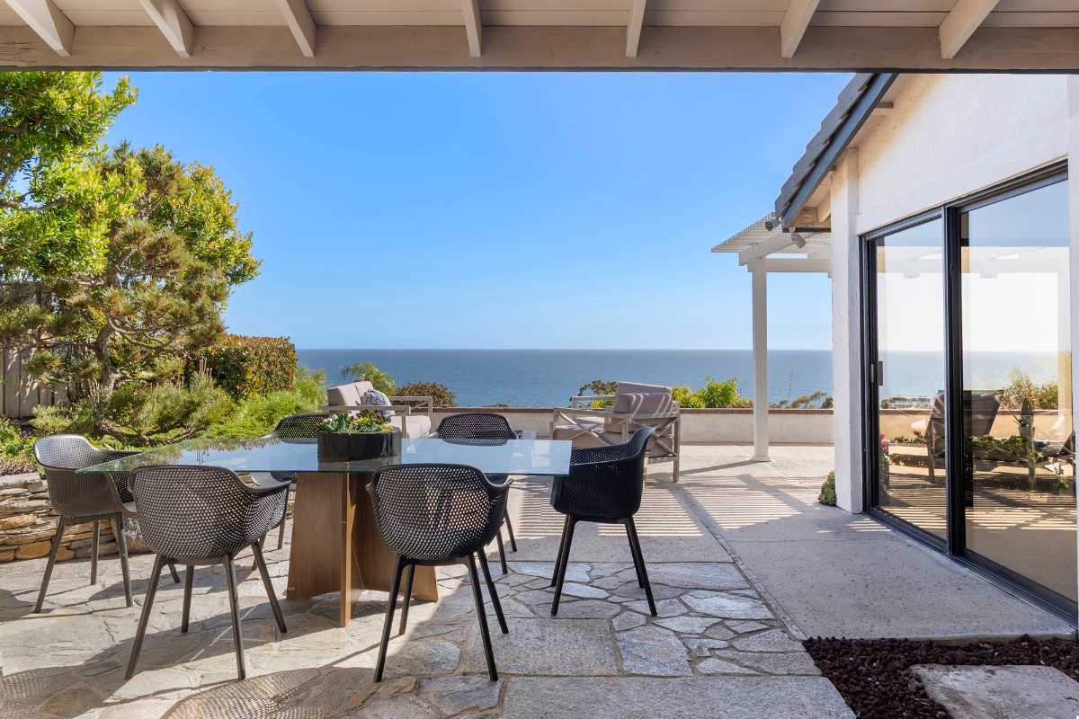 Outdoor patio with dining table and ocean views from Dana Point’s exclusive homebuyer communities
