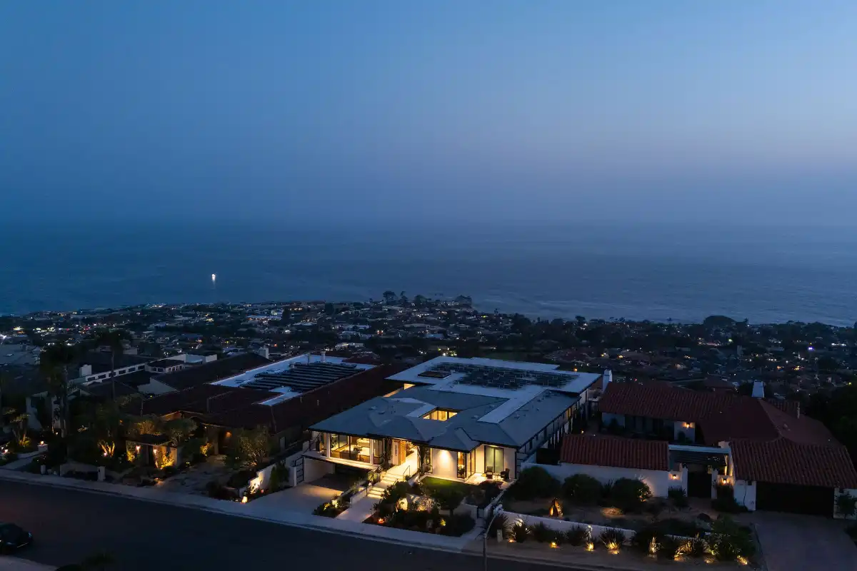 Aerial view of a Dana Point luxury home at dusk, with ocean view in the distance, requiring a smart budget and preapproval to purchase your Orange County home with a mortgage