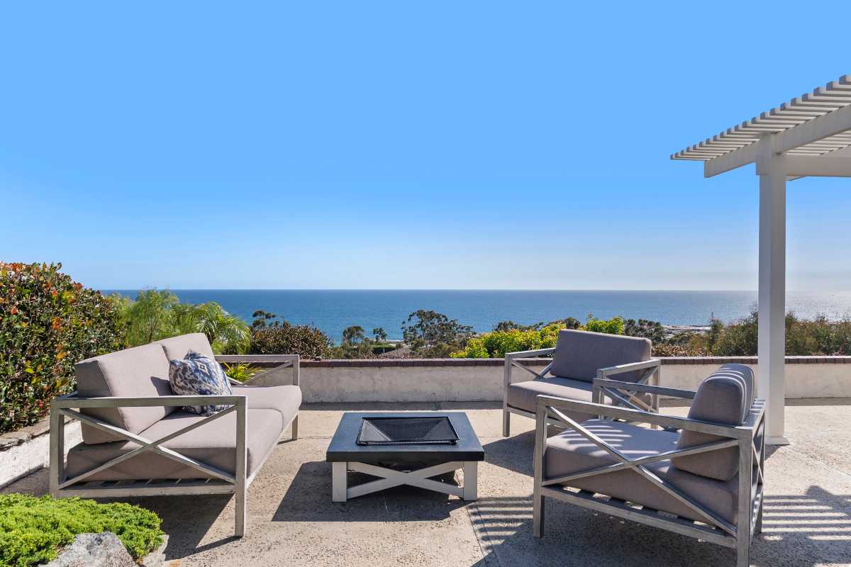 Outdoor living area with patio furniture and ocean views, a very desirable home to make an offer for homebuyers and their buying agent realtors in OC